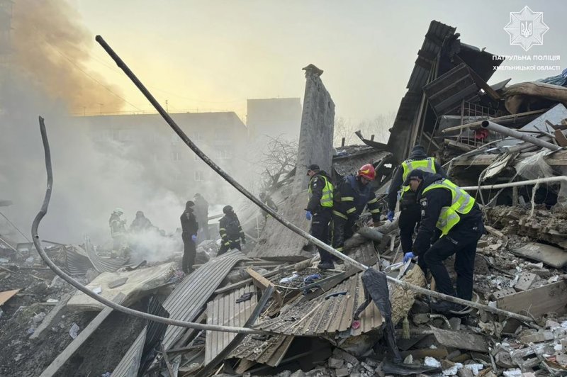 National Police of Ukraine rescuers at the scene of a Russian missile strike in the city of Khmelnytskyi, Ukraine, Friday. At least two people were killed and eight others were injured, the state emergency service reported. The Ukrainian army intercepted 92 missiles, at least one of which violated Polish air space. EPA-EFE/NATIONAL POLICE OF UKRAINE.