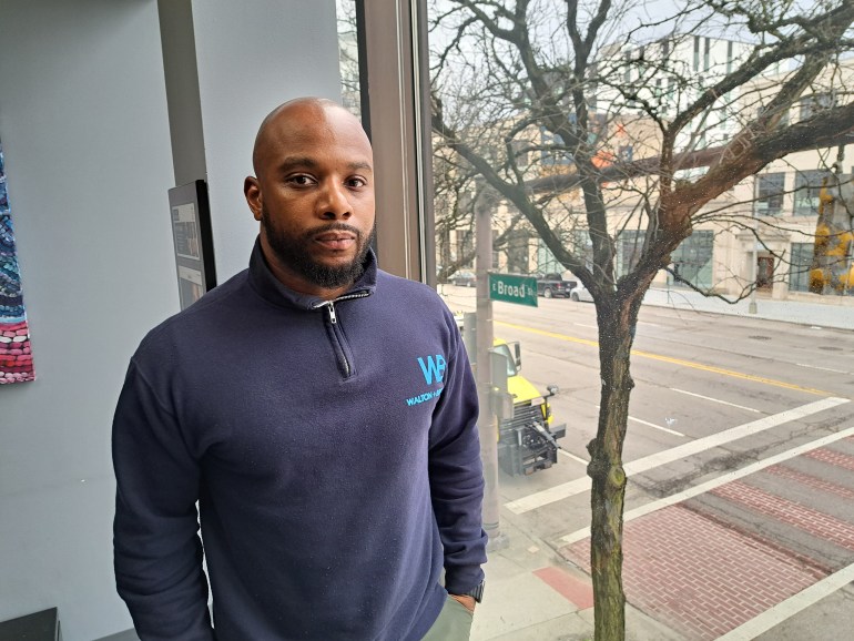 Lawyer Sean Walton poses in front of an office window