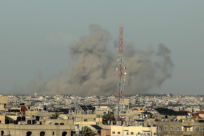 A pall of black smoke billows above southern Gaza on Wednesday amid continued Israeli bombardment of targets in the strip even as talks to negotiate as cease-fire were underway in the Egyptian capital Cairo. Photo by Ismael Mohamad/UPI