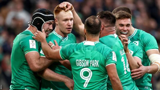 Frawley is congratulated by Ireland team-mates after scoring a try against Wales in the second half