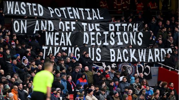 Crystal palace fans protest against the club's board in a recent Premier League game against Arsenal