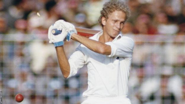 David Gower plays a cross-bat shot wearing whites and no helmet