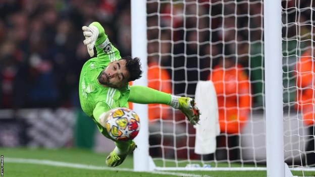 Arsenal goalkeeper David Raya saves a penalty against Porto in the Champions League last-16 shootout
