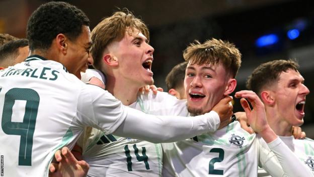 Northern Ireland players celebrate after Conor Bradley's goal against Scotland