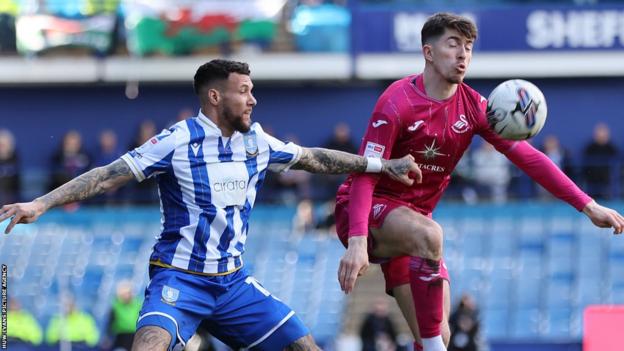 Josh Key and Marvin Johnson compete for possession during Swansea's draw at Sheffield Wednesday