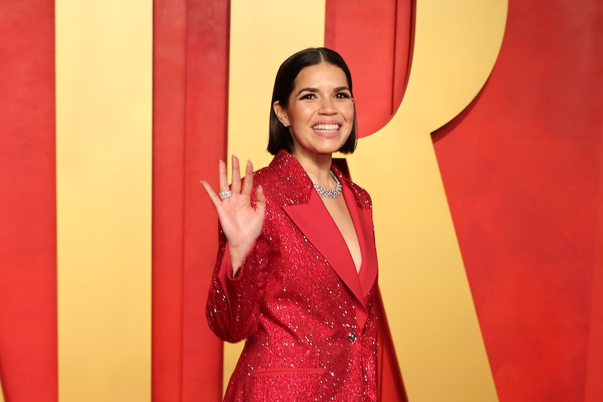 America Ferrera wears a red suit jacket dress.