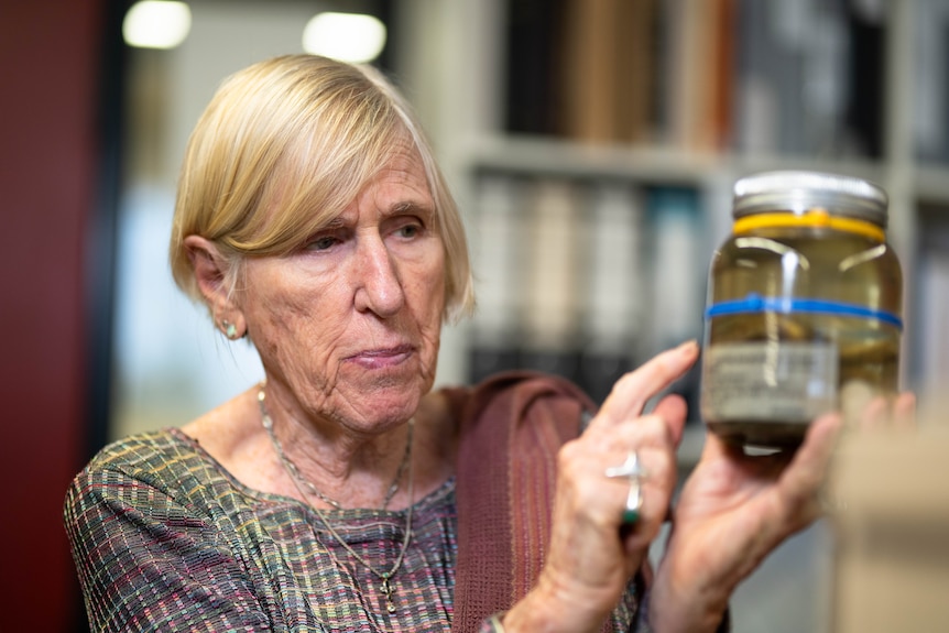 Portrait of a woman with worm specimens