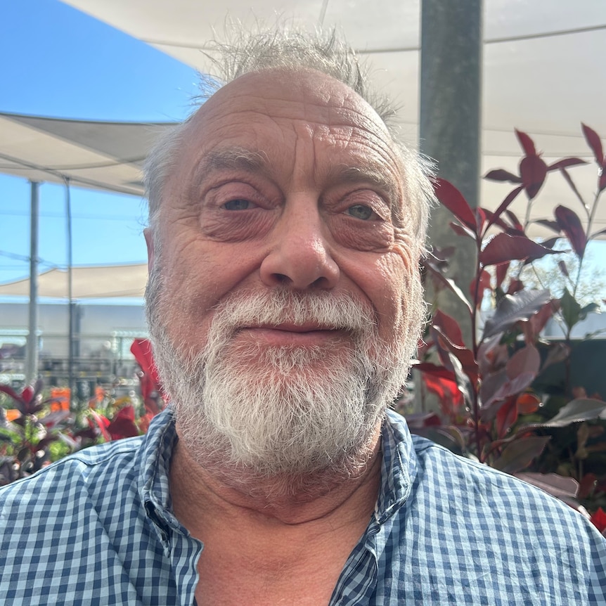 portrait of man with white beard and blue eyes. 