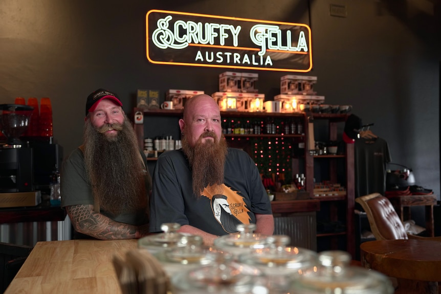 Two men with long beards sitting in a cafe.