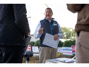 Bob Fulton speaks with members of the Brunswick County Democratic Party outside of an early voting location in Southport. Photographer: Madeline Gray/Bloomberg