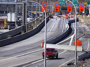 Diverted traffic, including an ambulance on a call, passes a closed portion of the Washington Bridge, Friday, March 8, 2024, in East Providence, R.I. The closure of a section of the bridge, and onramps, due to failure of some bridge components, has caused a significant loss to local businesses.