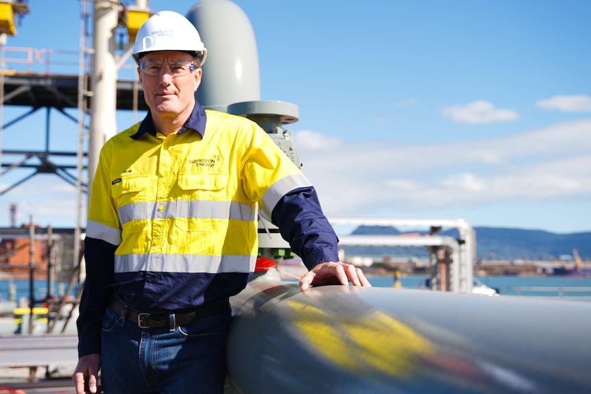 Man standing next to pipe