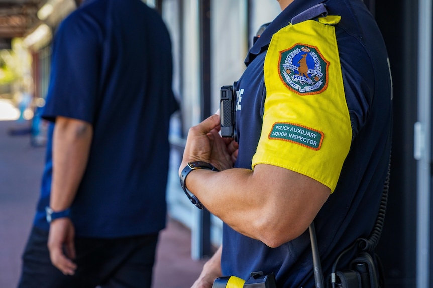 The torso of a police office standing in a street