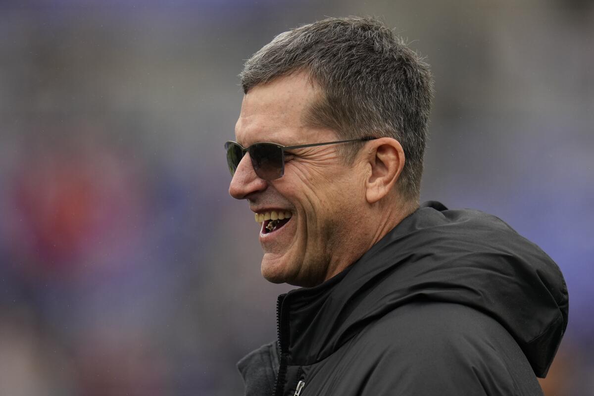  Chargers new head coach Jim Harbaugh walks on the field before an AFC Championship game.