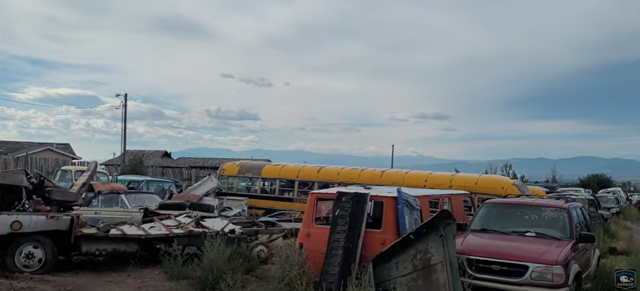 In the mix of abandoned vehicles an old yellow school bus could be seen