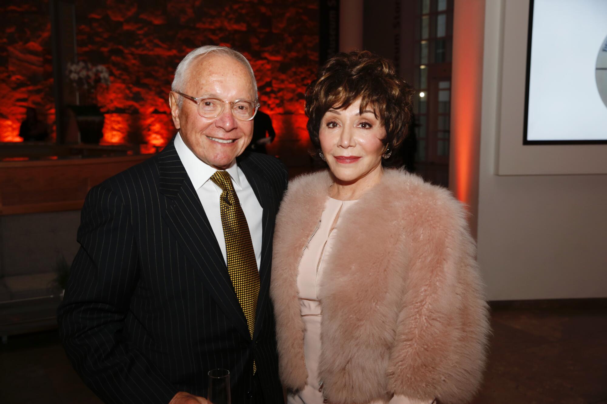 A portrait of Stewart and Lynda Resnick in formal attire 