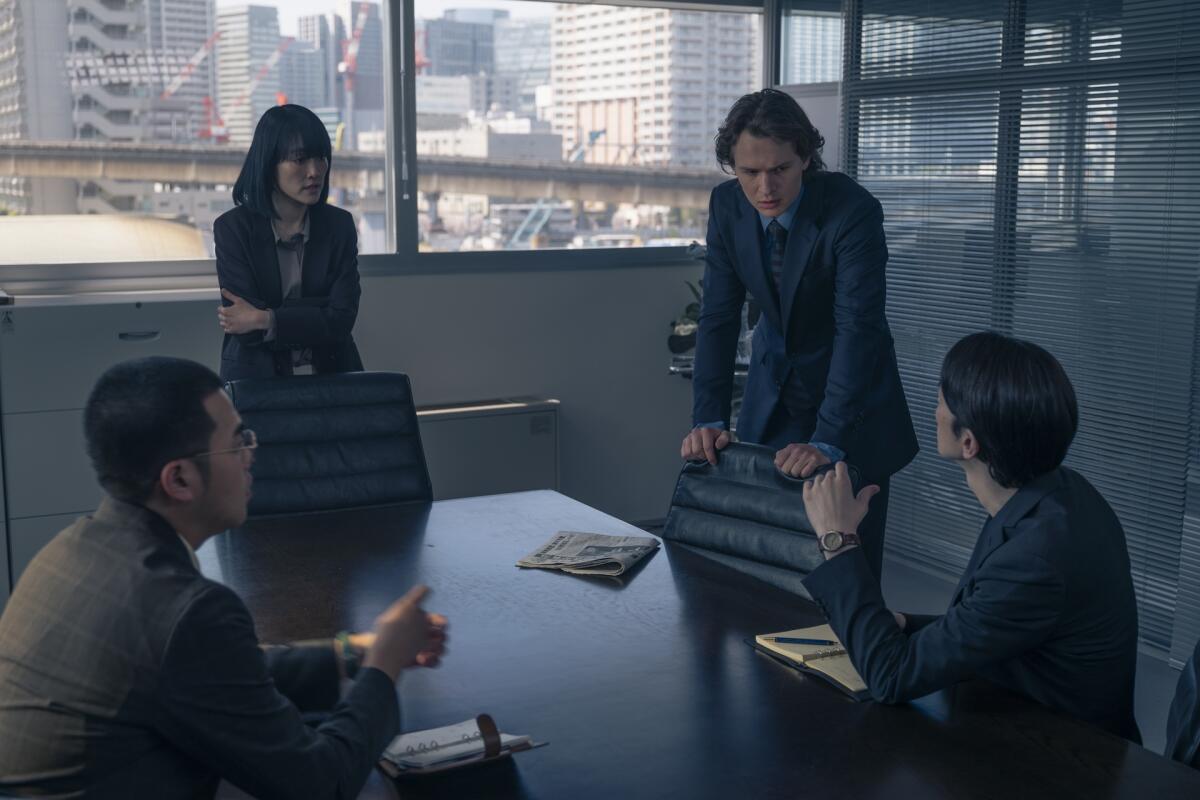 Four journalists meet in a conference room