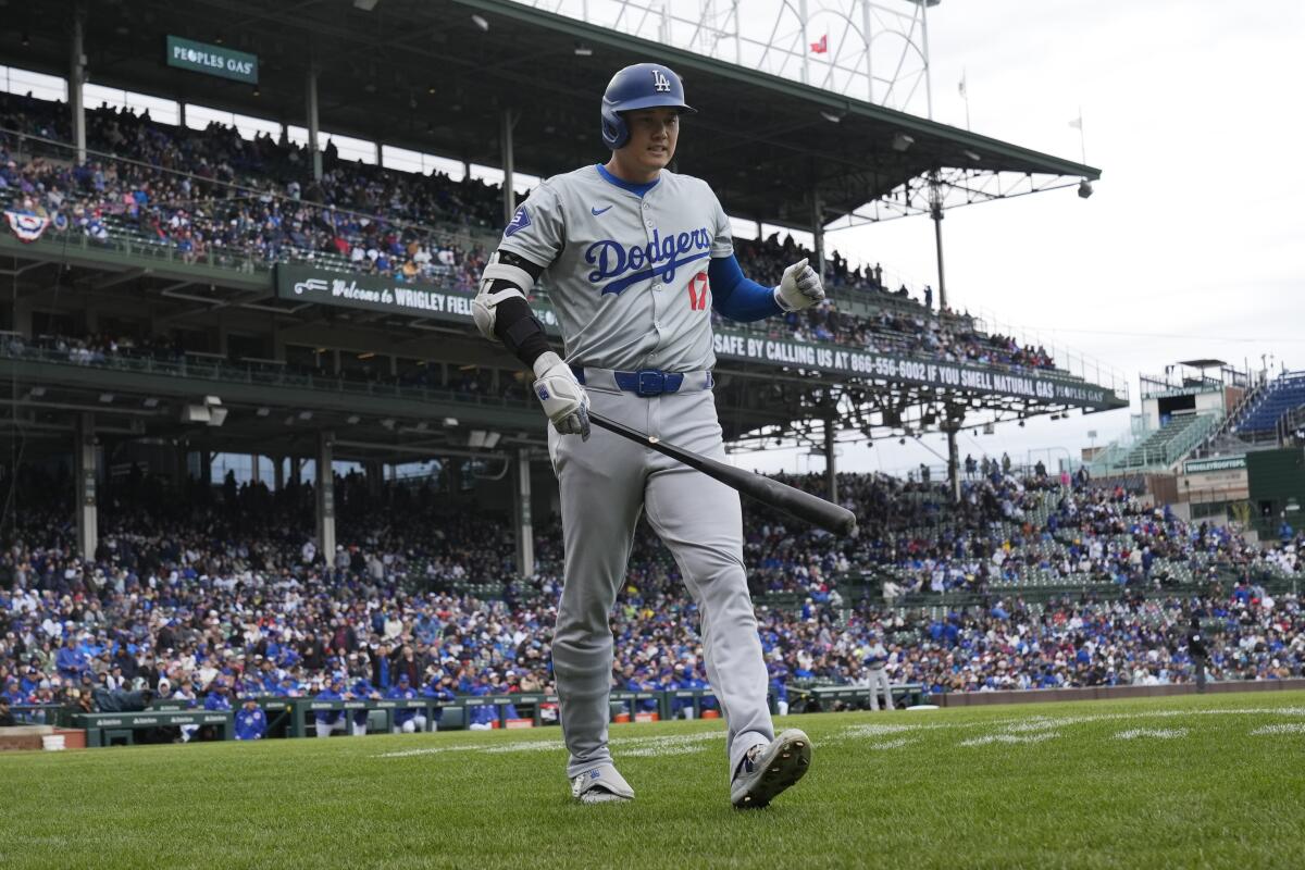 Dodgers star Shohei Ohtani walks back to the dugout after striking out against the Cubs in the first inning.