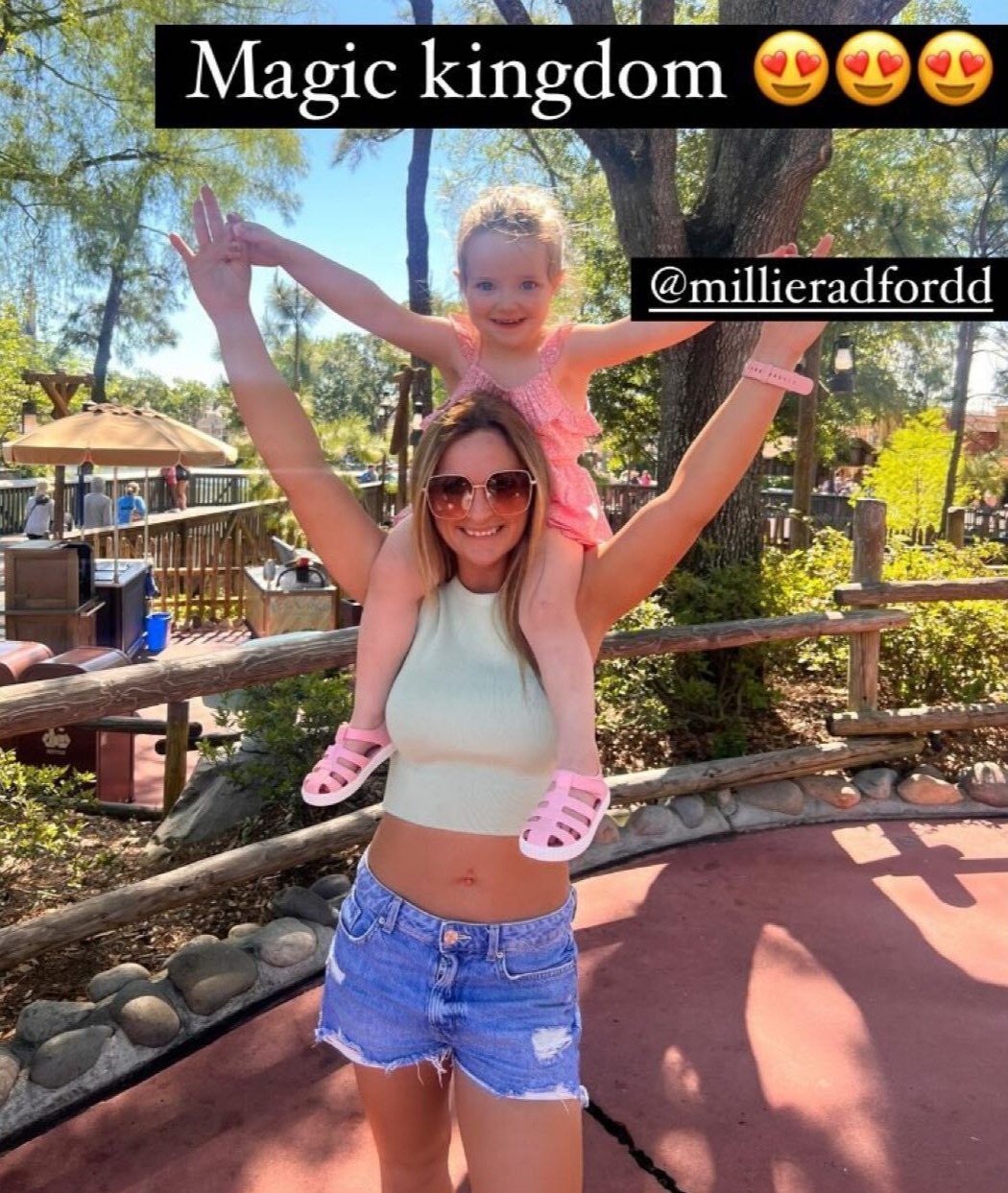 Millie's sister Sophie posed up with Ophelia on her shoulders as they hit the Magic Kingdom