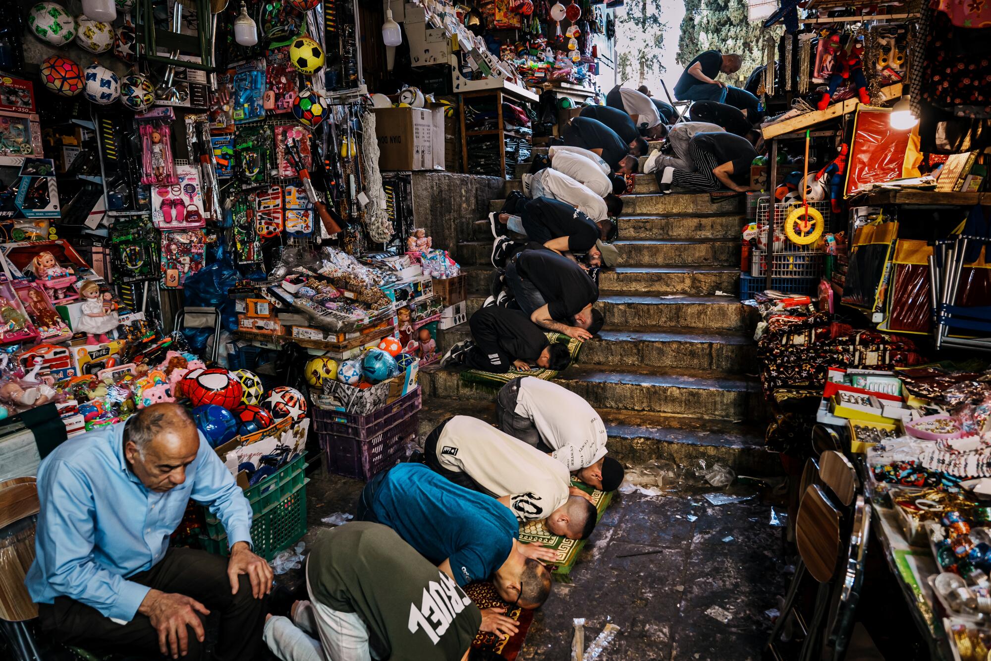 An overflow of worshippers stream out into the market entrances that lead into the Al Aqsa Mosque compound.