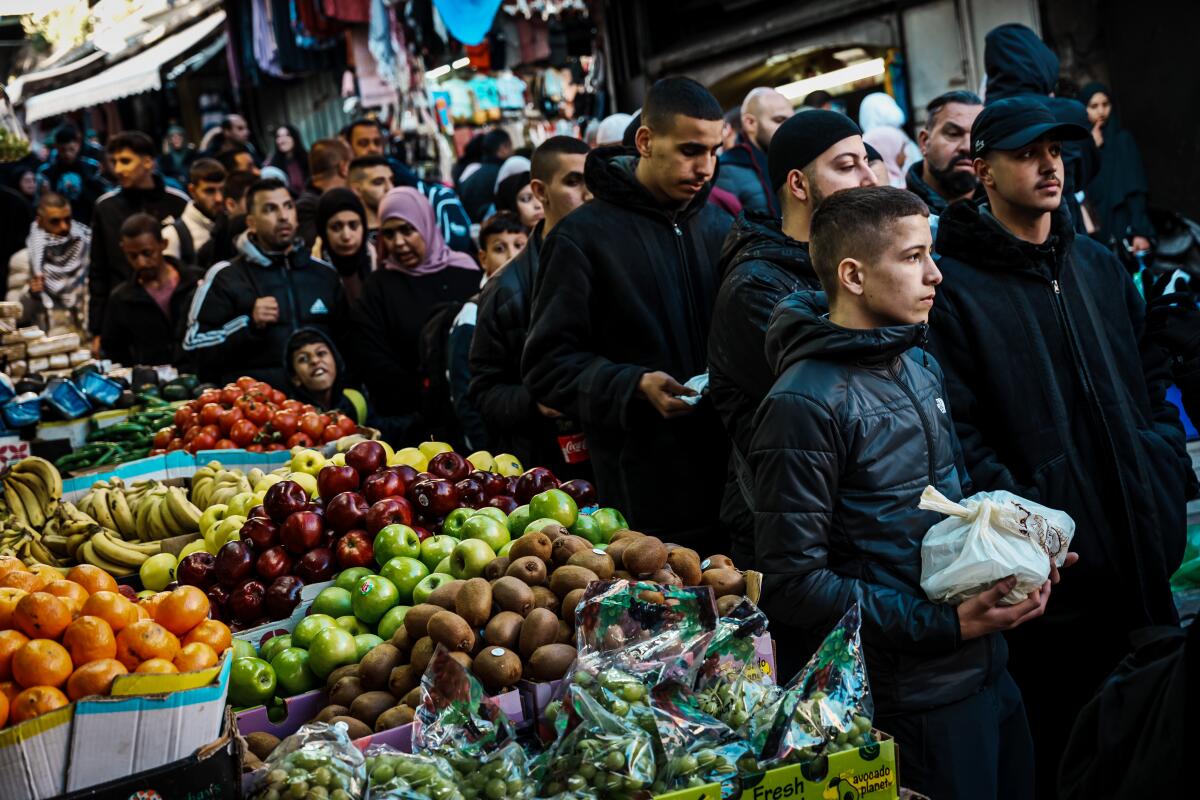 People walk to Al Aqsa Mosque carrying their Iftar meals.