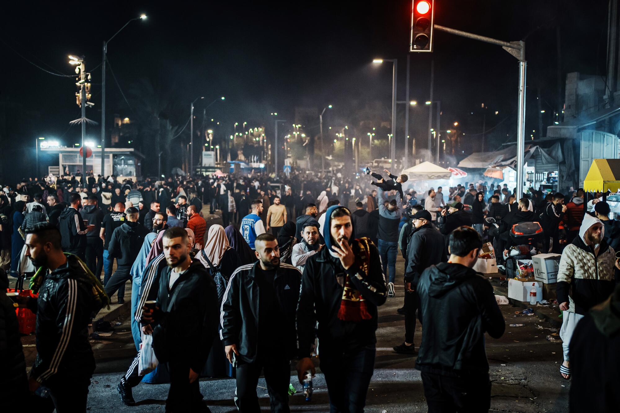 Crowds move around at night outside the Old City of Jerusalem near Damascus Gate.