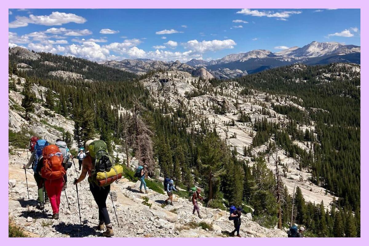 Hikers make their way down a rocky mountainside.