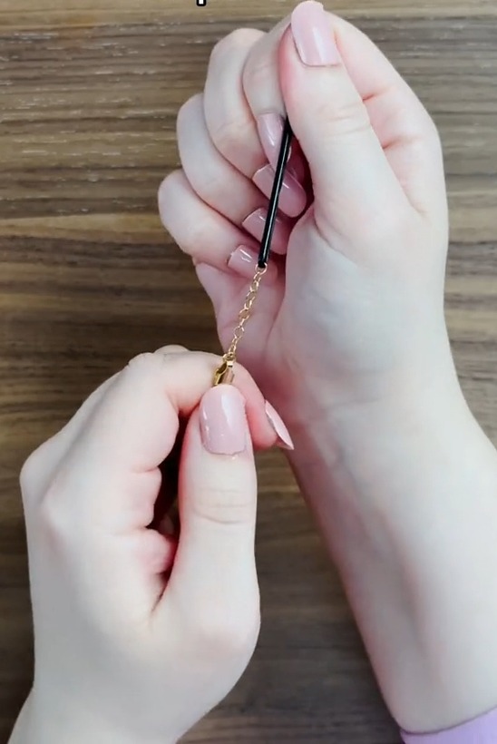 Her easy and cheap tip involved feeding a bobby pin through the clasp and pulling down