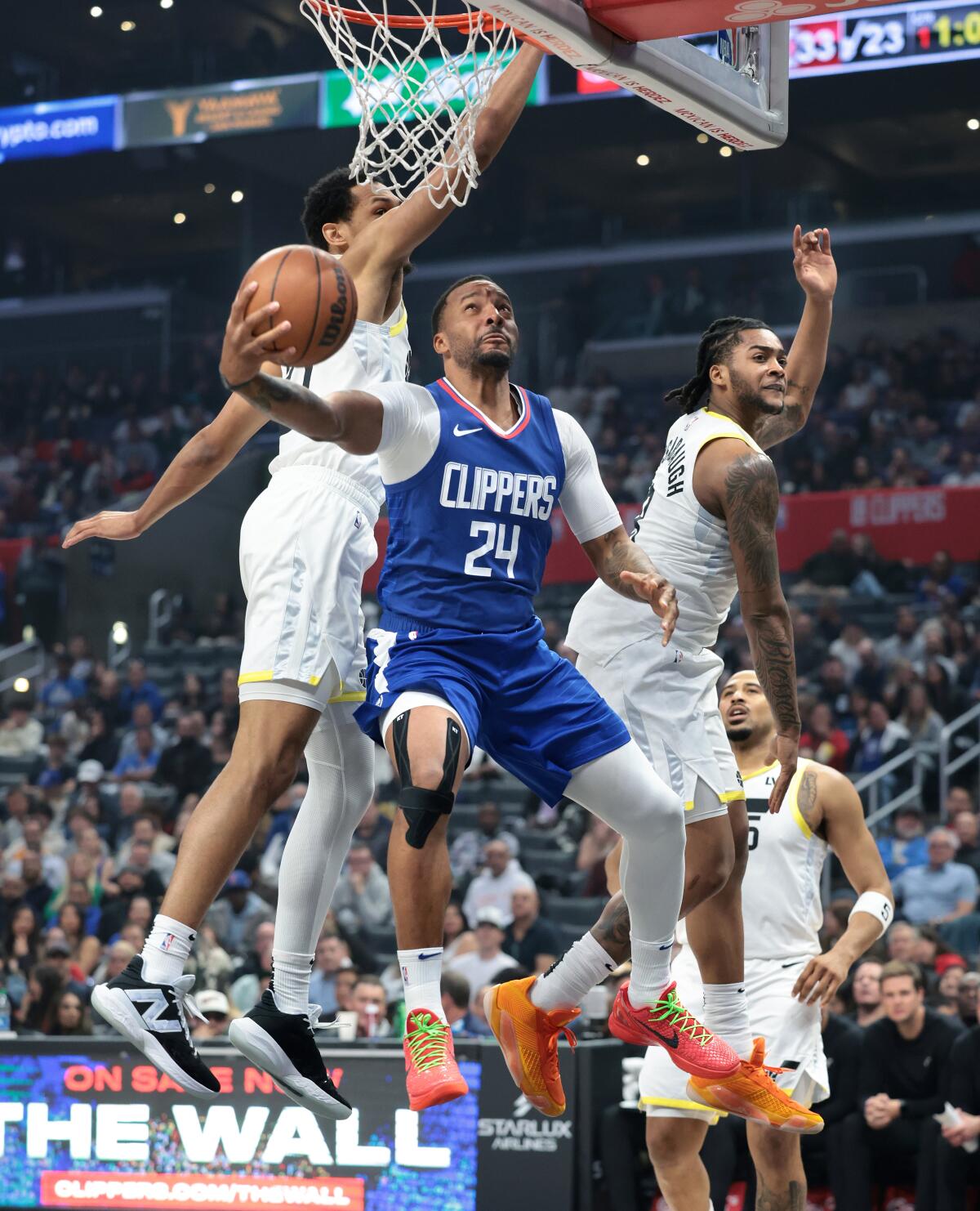 Clippers guard Norman Powell scores in front of Utah's Darius Bazley, left, and Brice Sensabaugh.