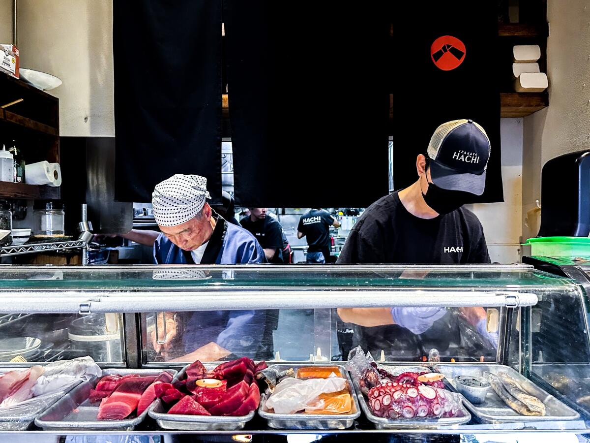 Chefs work behind the sushi counter at Izakaya Hachi in Torrance.