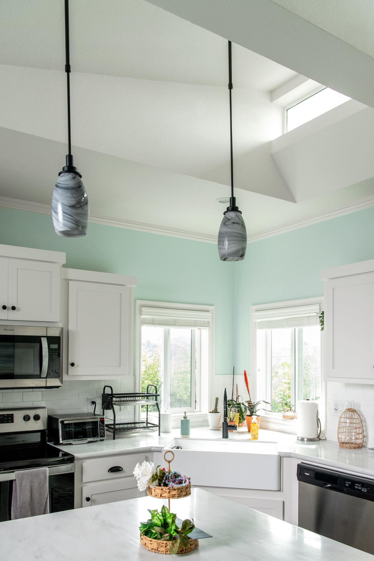 Windows and high ceilings open up the small space.