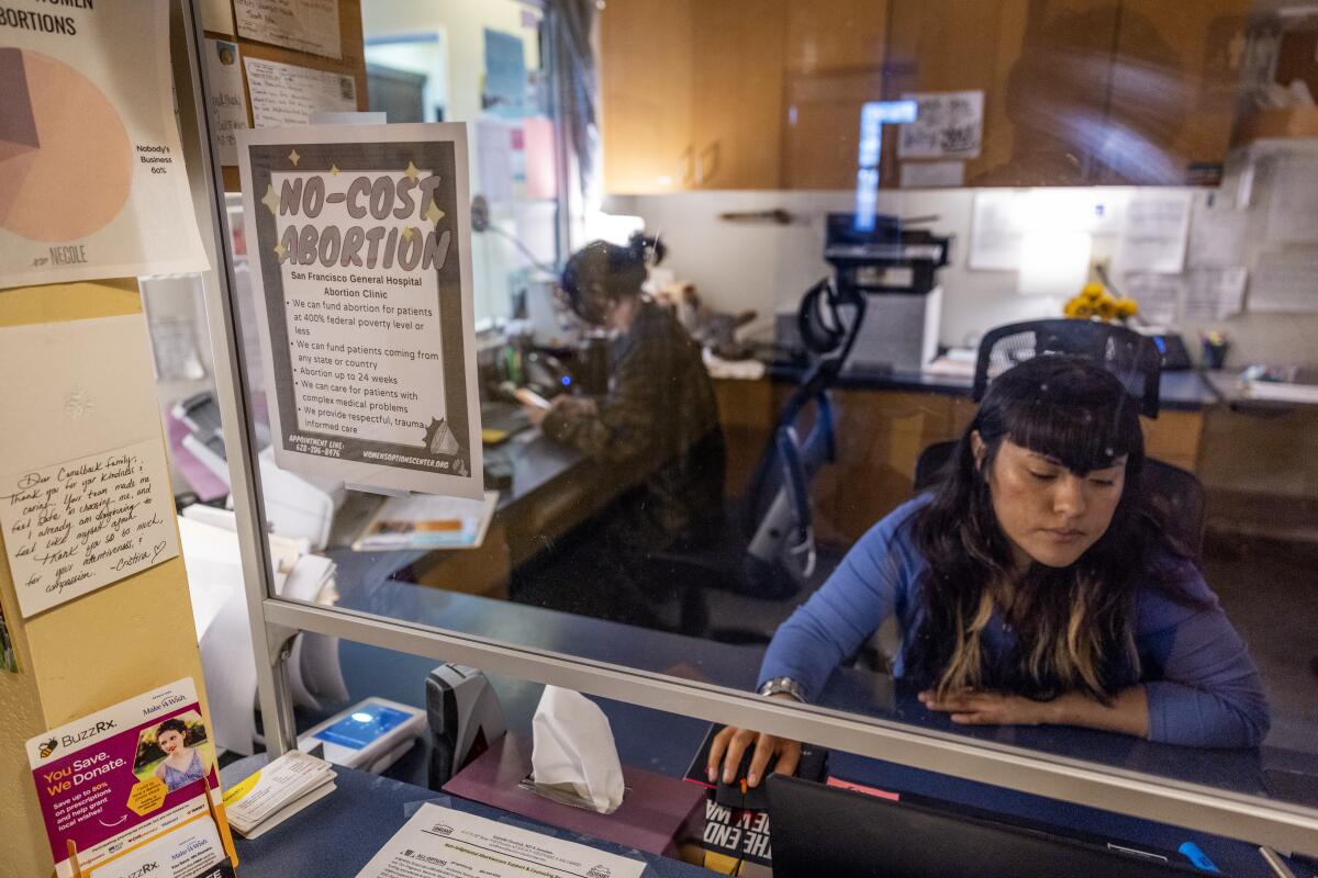 Information on a no-cost abortion clinic in San Francisco hangs on the glass at the 