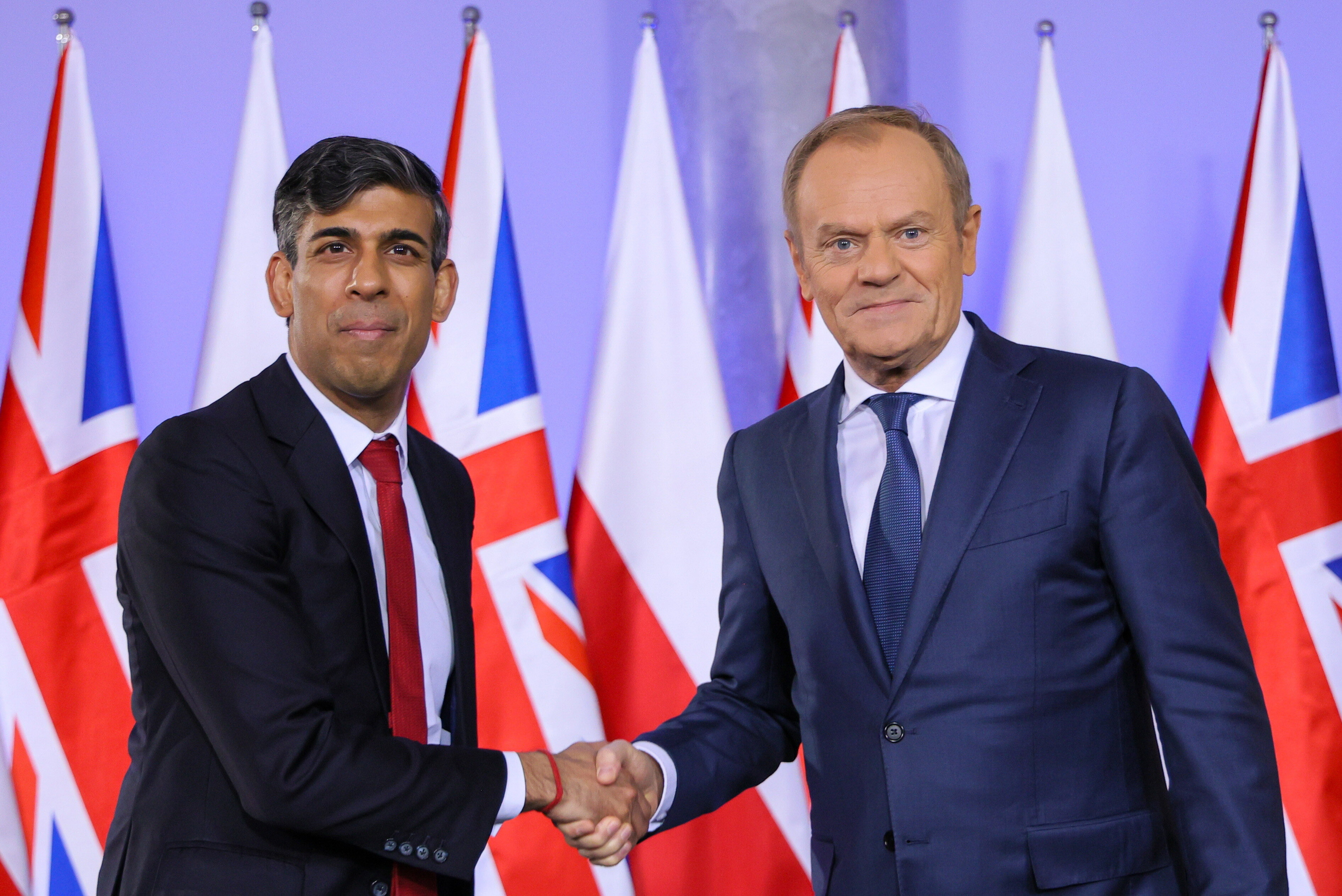 Polish Prime Minister Donald Tusk shakes hands with PM Rishi Sunak as he kicked off his two-day visit to Poland for crunch security talks