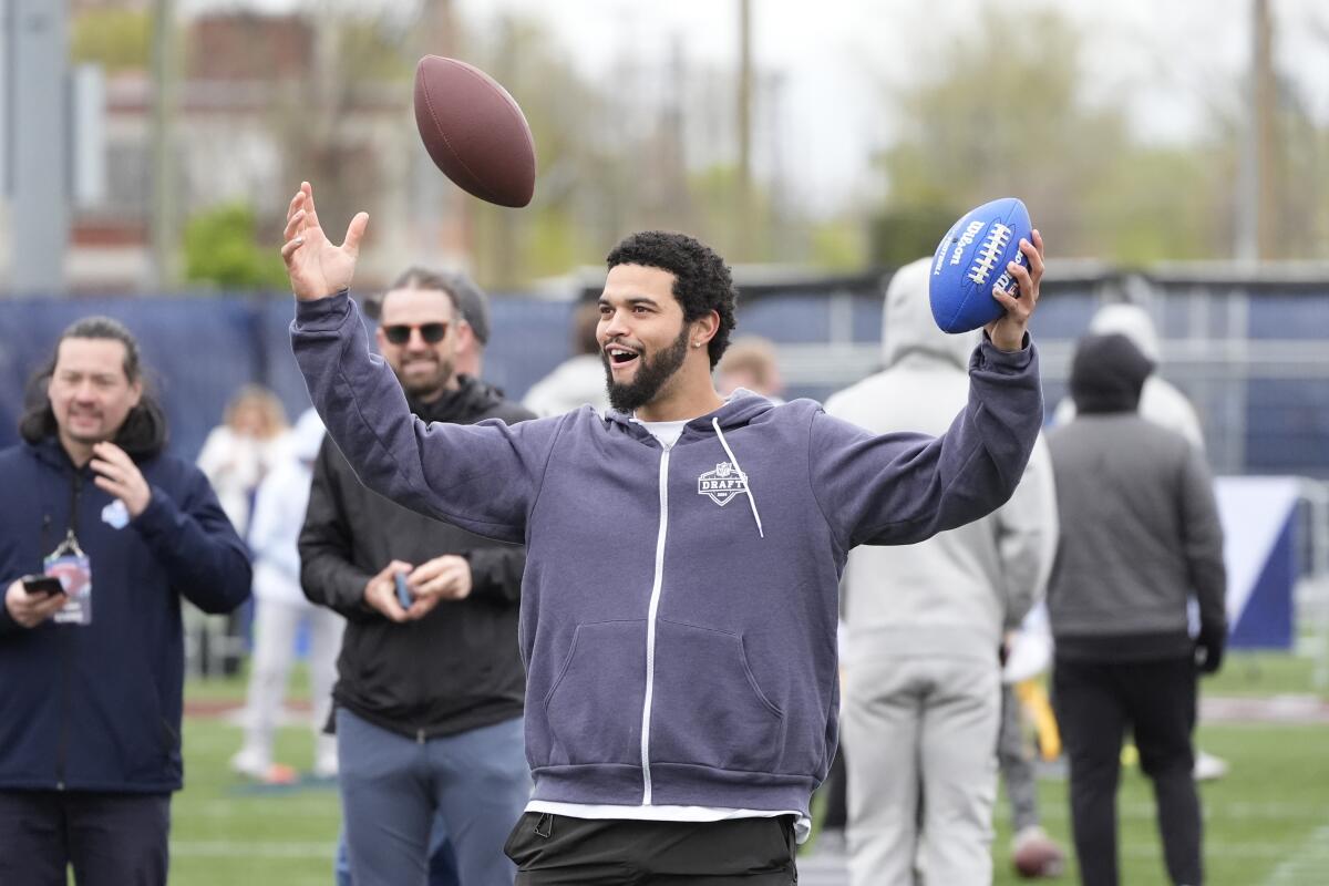 Caleb Williams reacts during an NFL Football Play Football Prospect Clinic with Special Olympics athletes in Detroit.