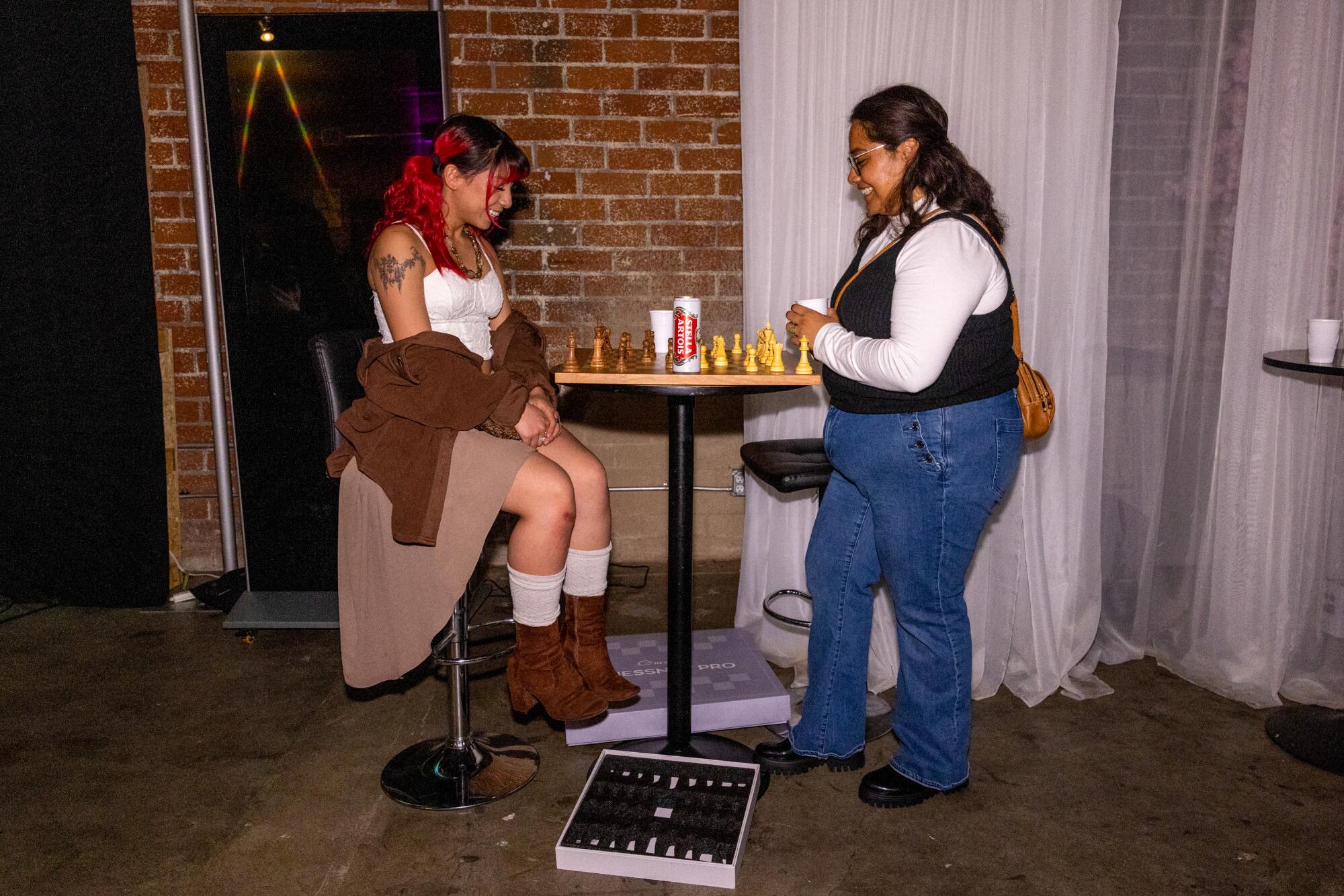 Two friends play a game of chess together.