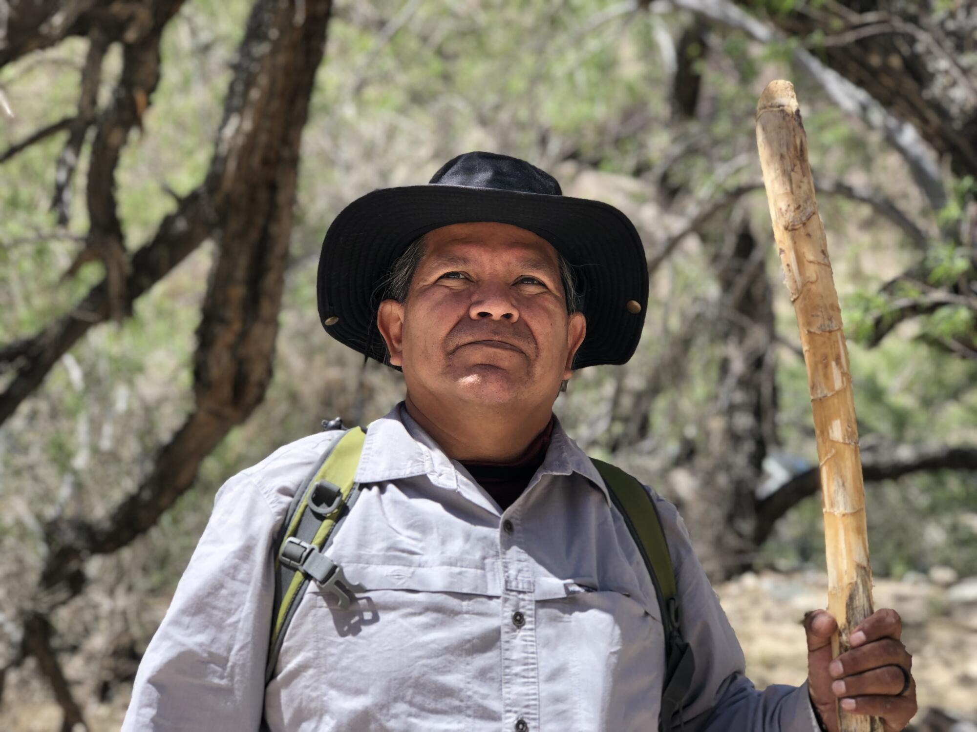 Thomas Tortez, wearing a hat and carrying a walking stick.