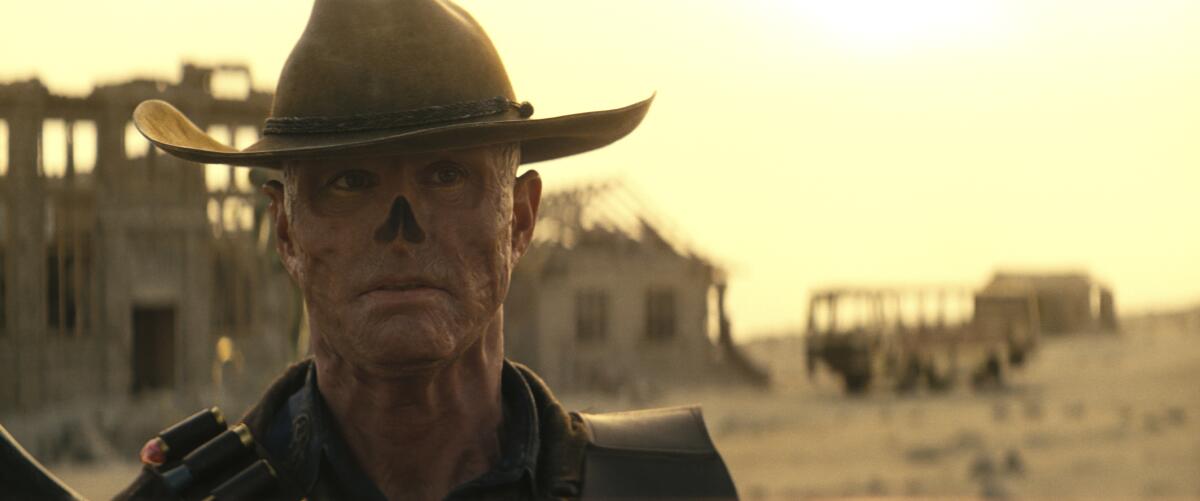 A ghoul in a cowboy hat in a desolate landscape.