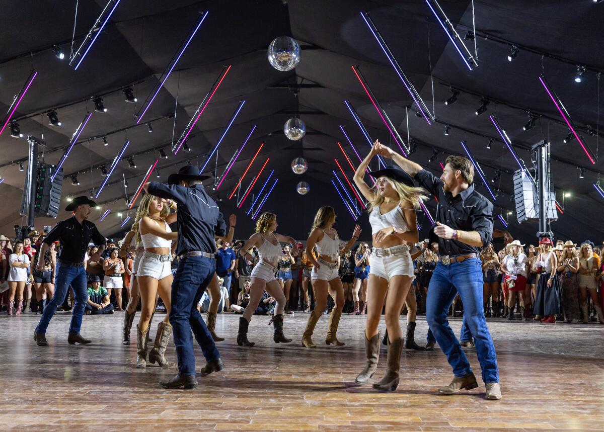 People dance under disco balls