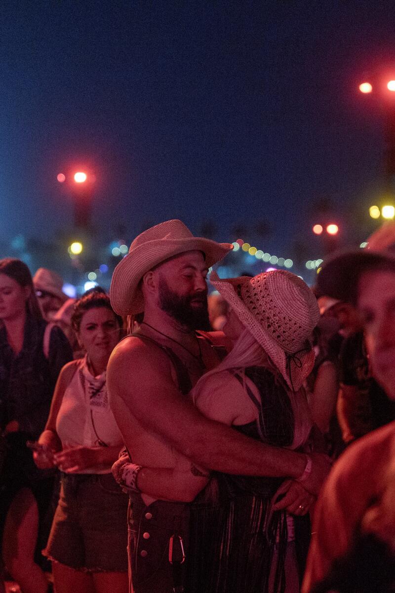 Graham Drew and Kassandra Ballar dance as Friday headliner Eric Church performs.