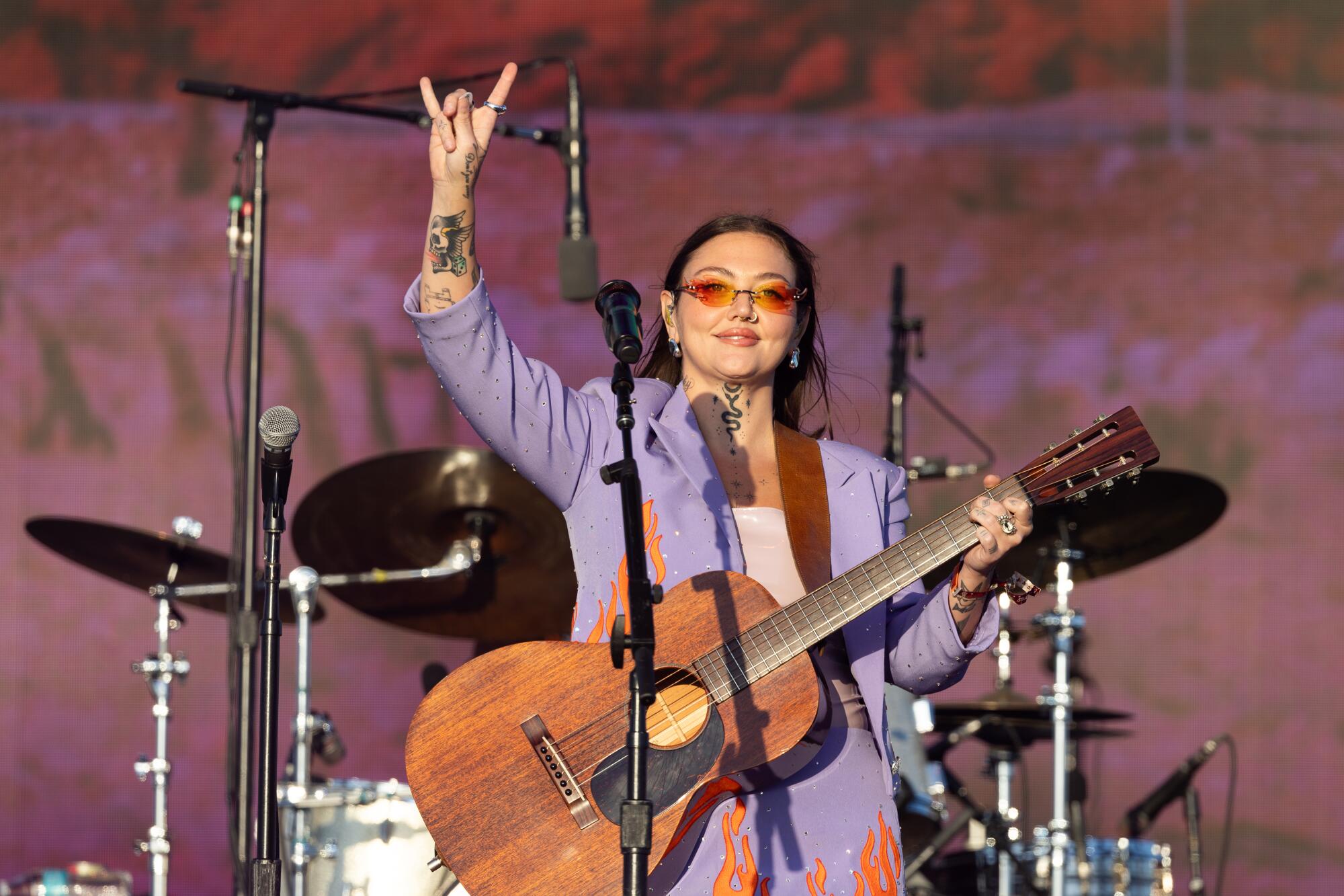 Elle King makes a hand gest from the stage at the Stagecoach Country Music Festival.