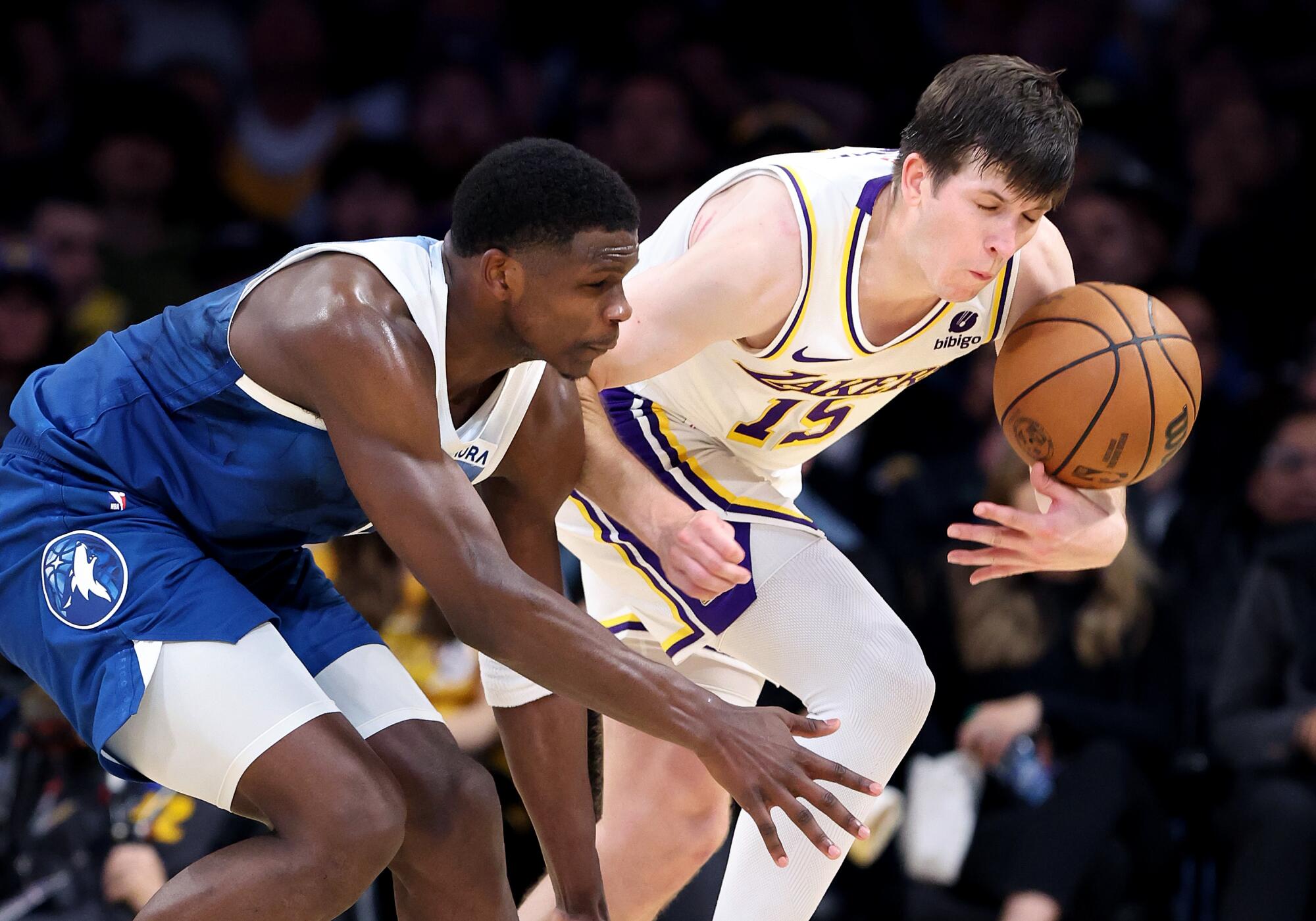 Lakers guard Austin Reaves steals the ball from Timberwolves guard Anthony Edwards during a game in March.