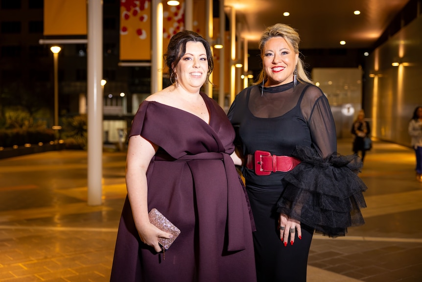 Karoline Dawe and Kylie Ward wearing nice evening dresses outside a gala event.