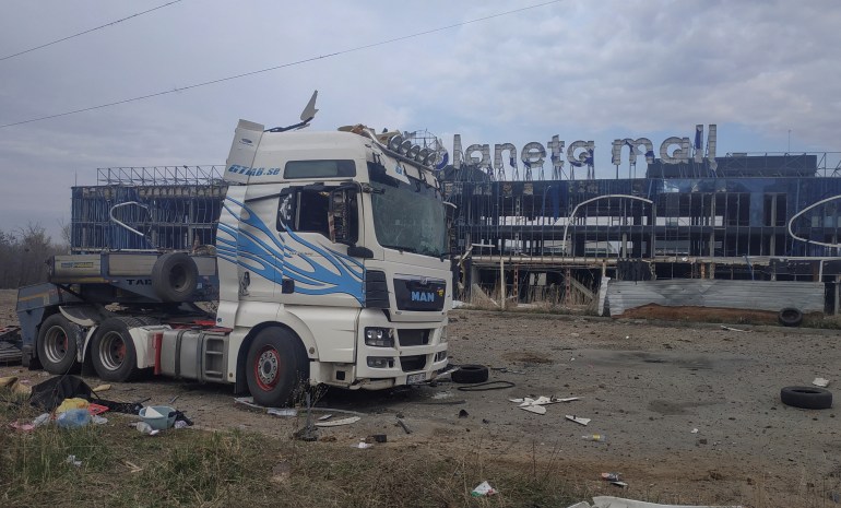 A view shows a truck and a building of a shopping mall damaged during Russian missile and drone strikes, amid Russia's attack on Ukraine, in Kharkiv