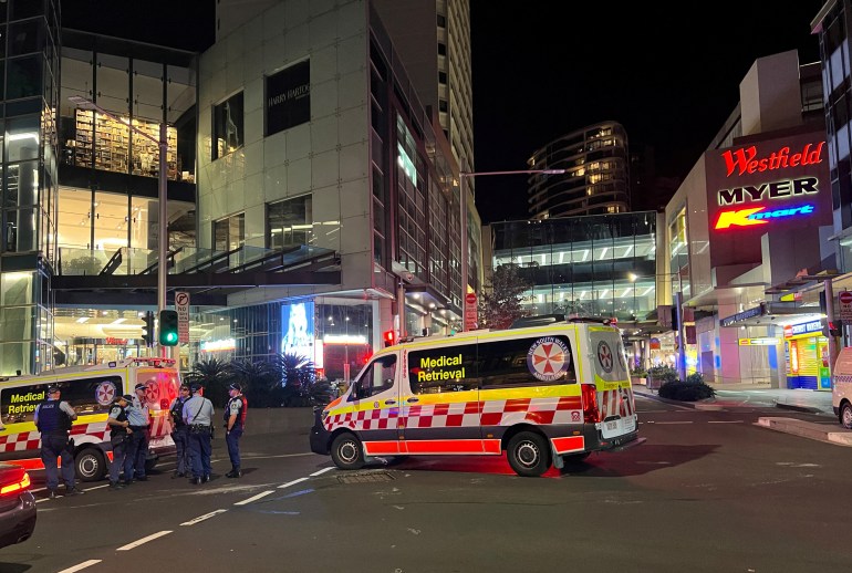 Police officers work at the scene outside Bondi Junction following reports