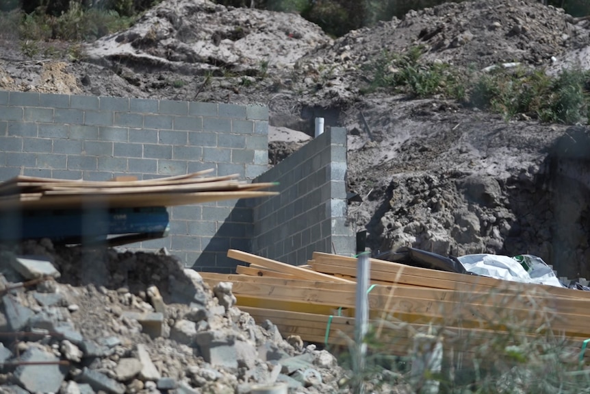 A building site with material strewn around.