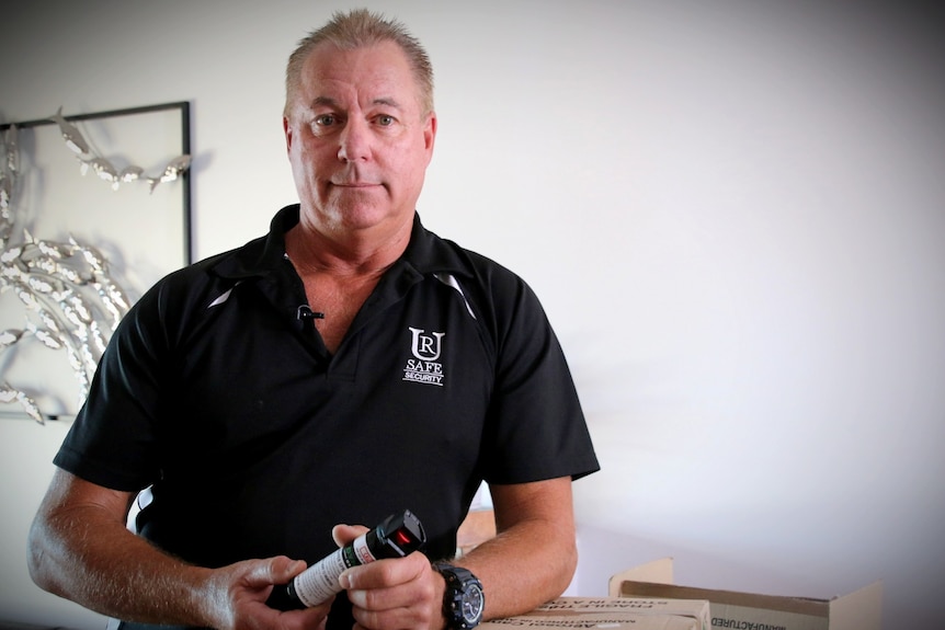 Jeff Rodwell holds a canister or bottle labelled as "pepper spray".