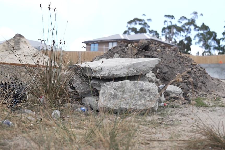 Slabs of concrete are strewn on a site.