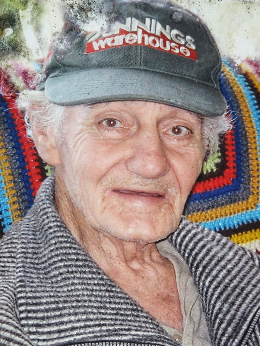 Portrait photograph William Halliday sitting in a chair wearing a cap. 