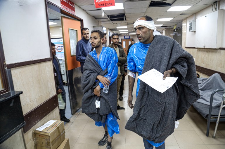 Mohamed Marshoud walking through hospital corridors with another man