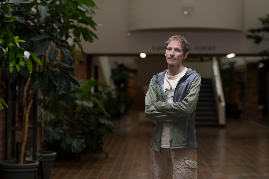 A man stands in the foyer of the ANU